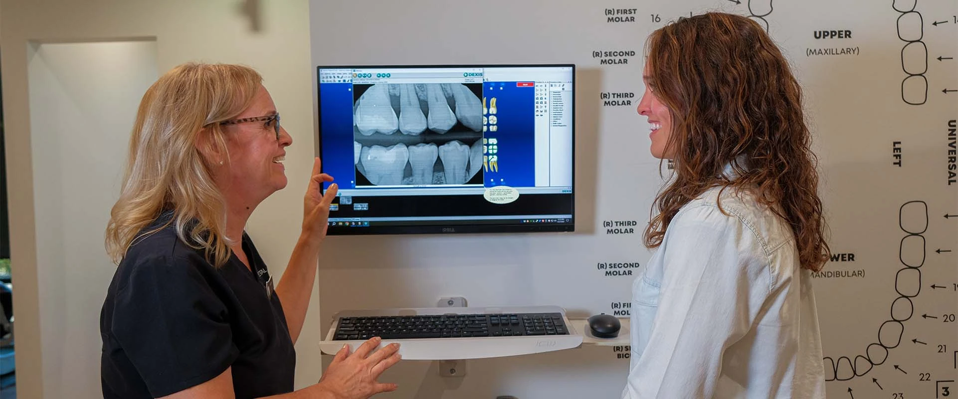 A staff member at Roseville Dental talking to a patient about dental implants in Roseville CA.