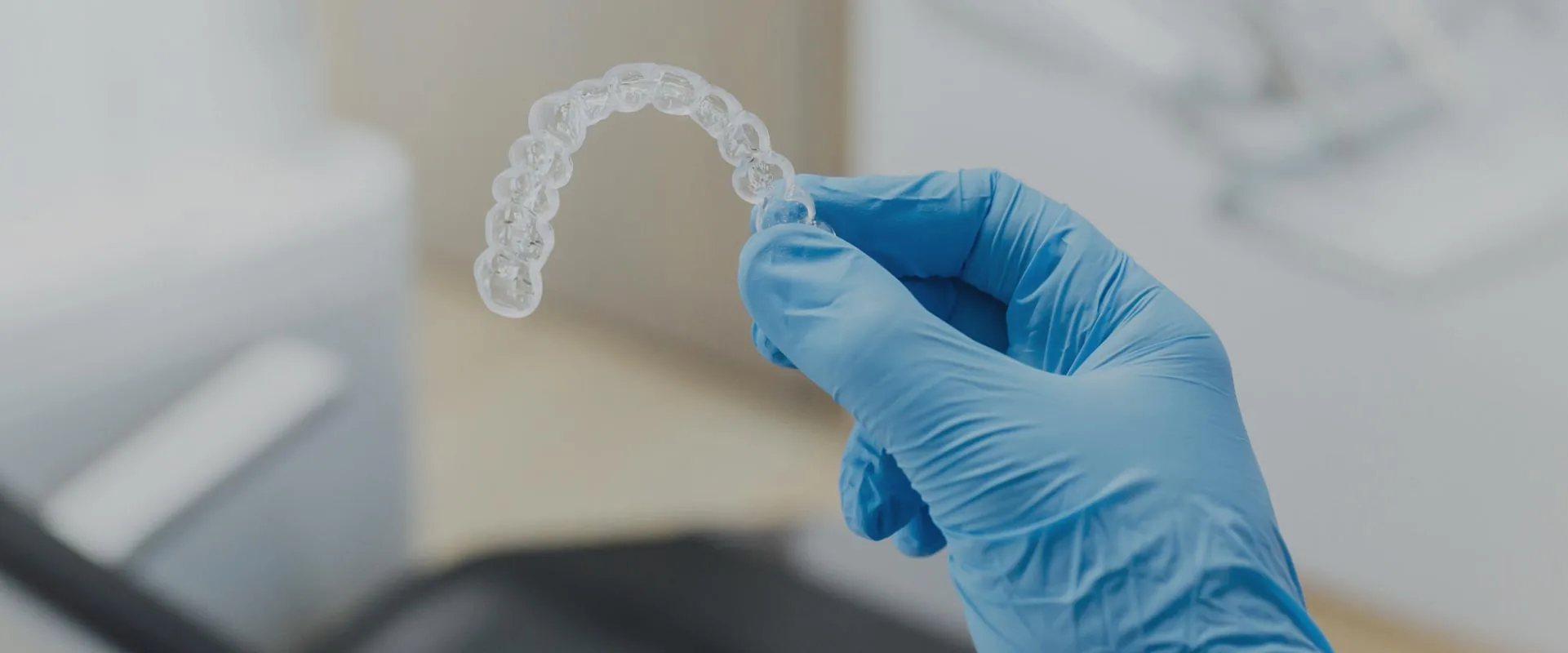 Dr. Haney holding Invisalign clear aligners