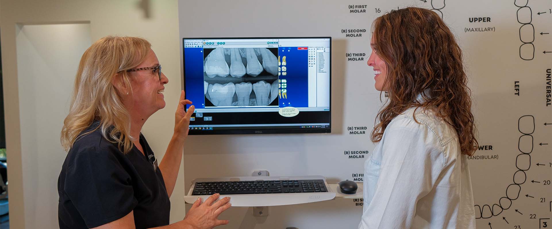 A staff member at Roseville Dental talking to a patient about dental implants in Roseville CA.